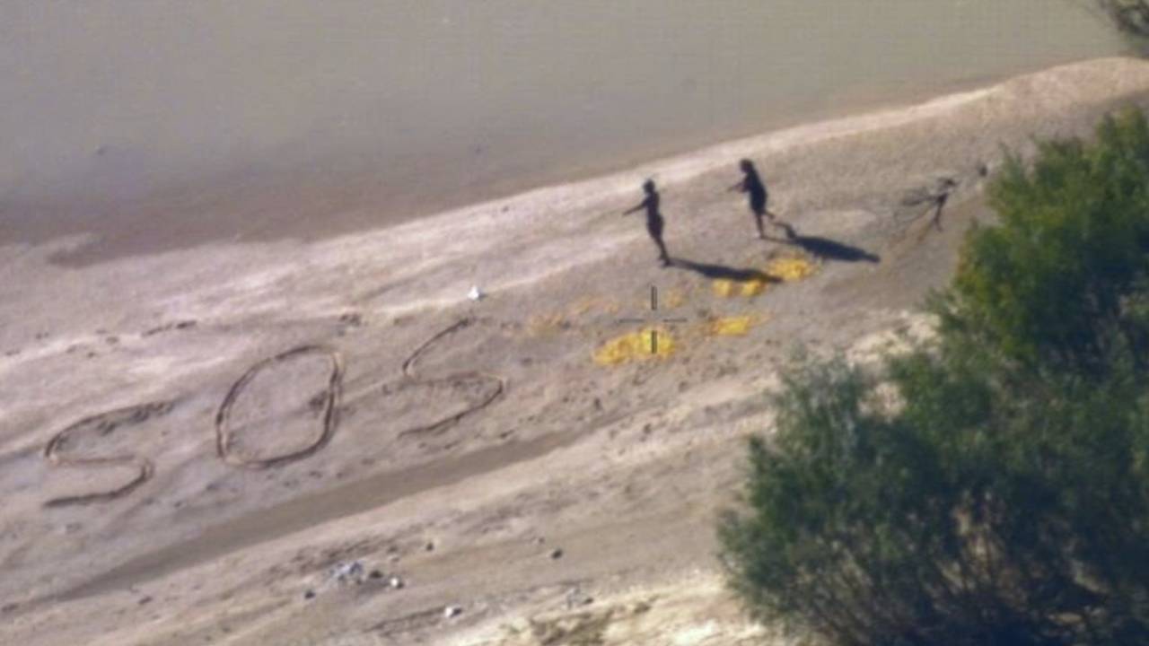 Group rescued after drawing SOS in sand