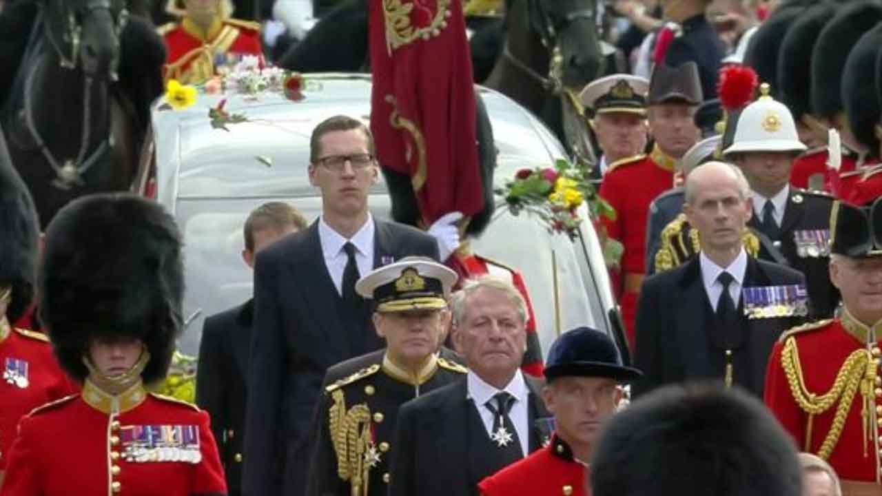 Who was that incredibly tall man in the Queen's funeral procession?
