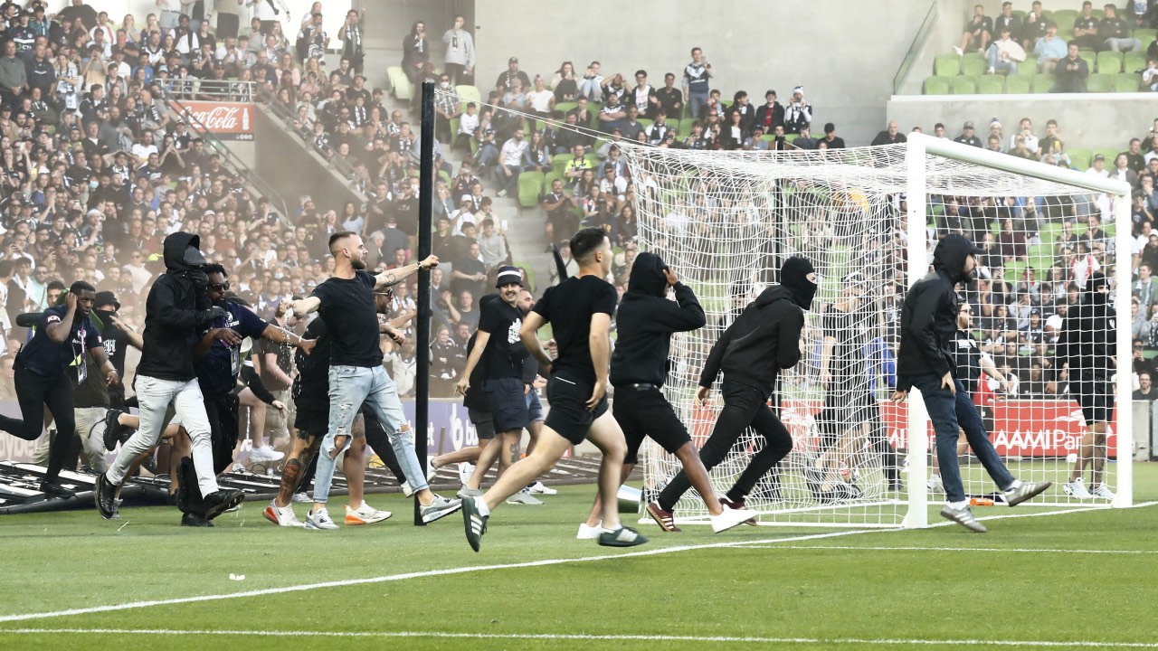 Photos released as men sought over violent pitch invasion