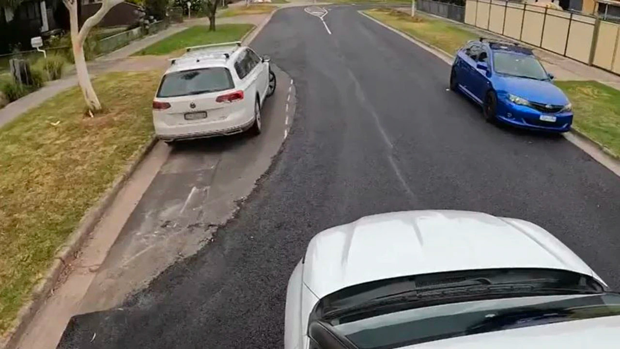 Embarrassing blunder sees road resurfaced around parked cars