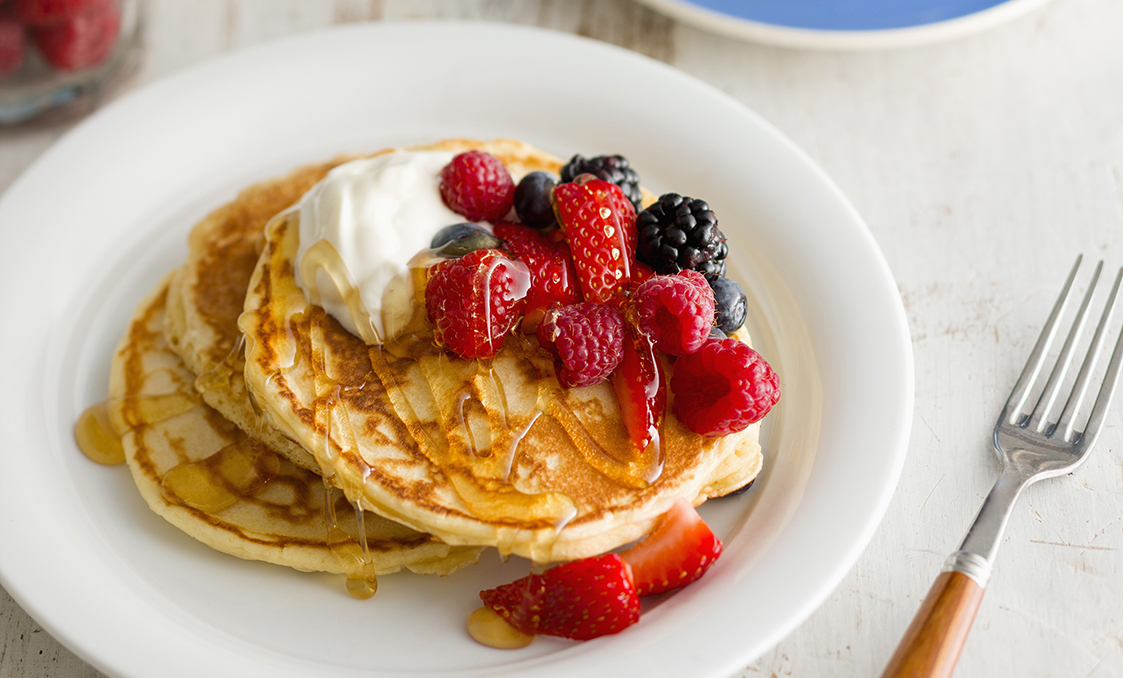 Pancakes with fresh berries, yoghurt and honey | OverSixty
