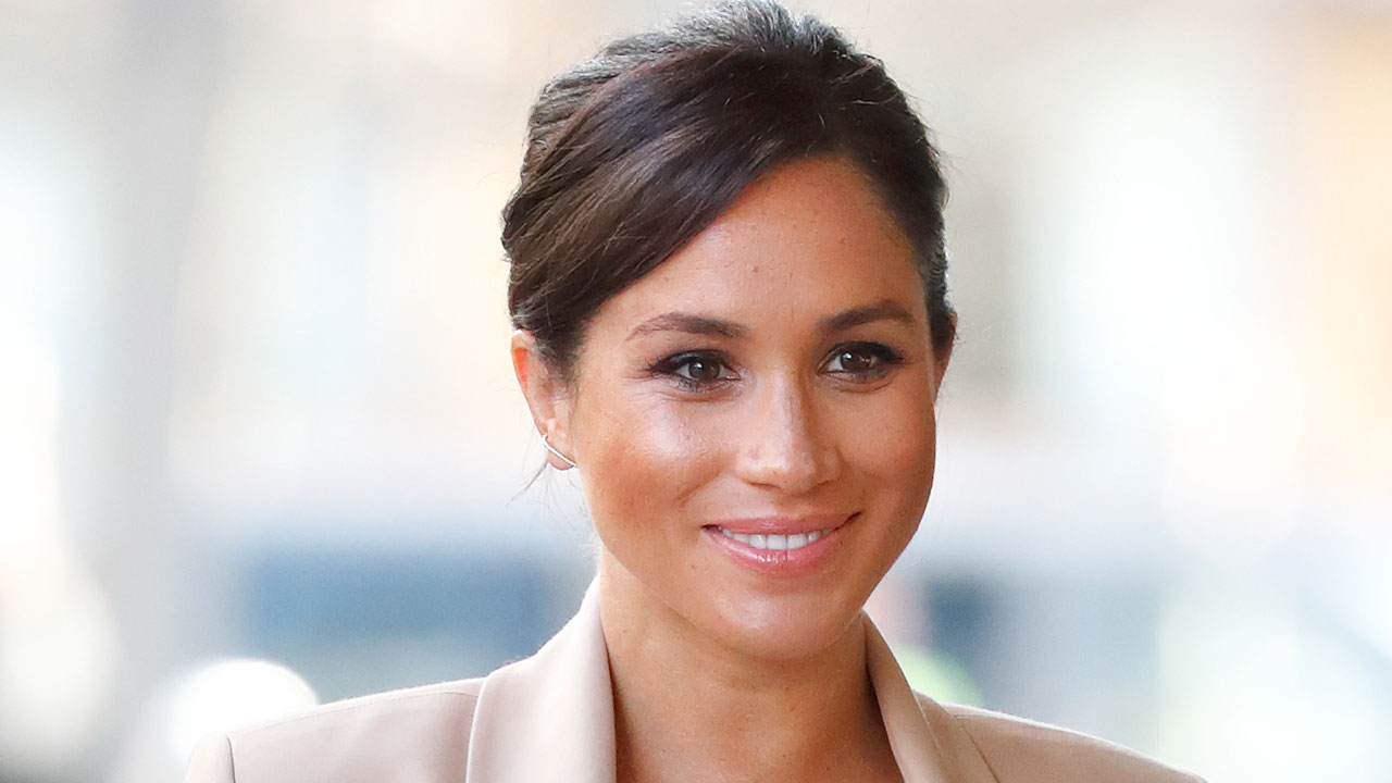 Duchess Meghan cradles baby bump wearing $800 heels in chic nude outfit