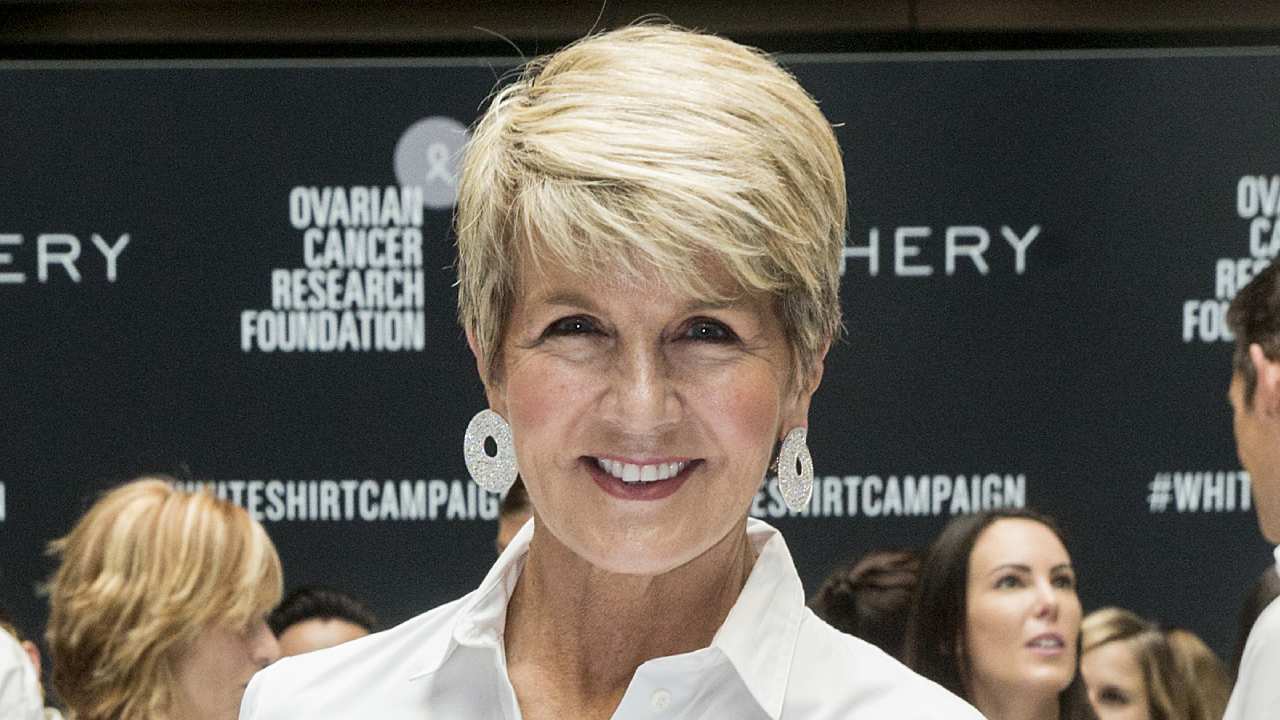 Julie Bishop struts the red carpet in daring red gown – and debuts new hairstyle