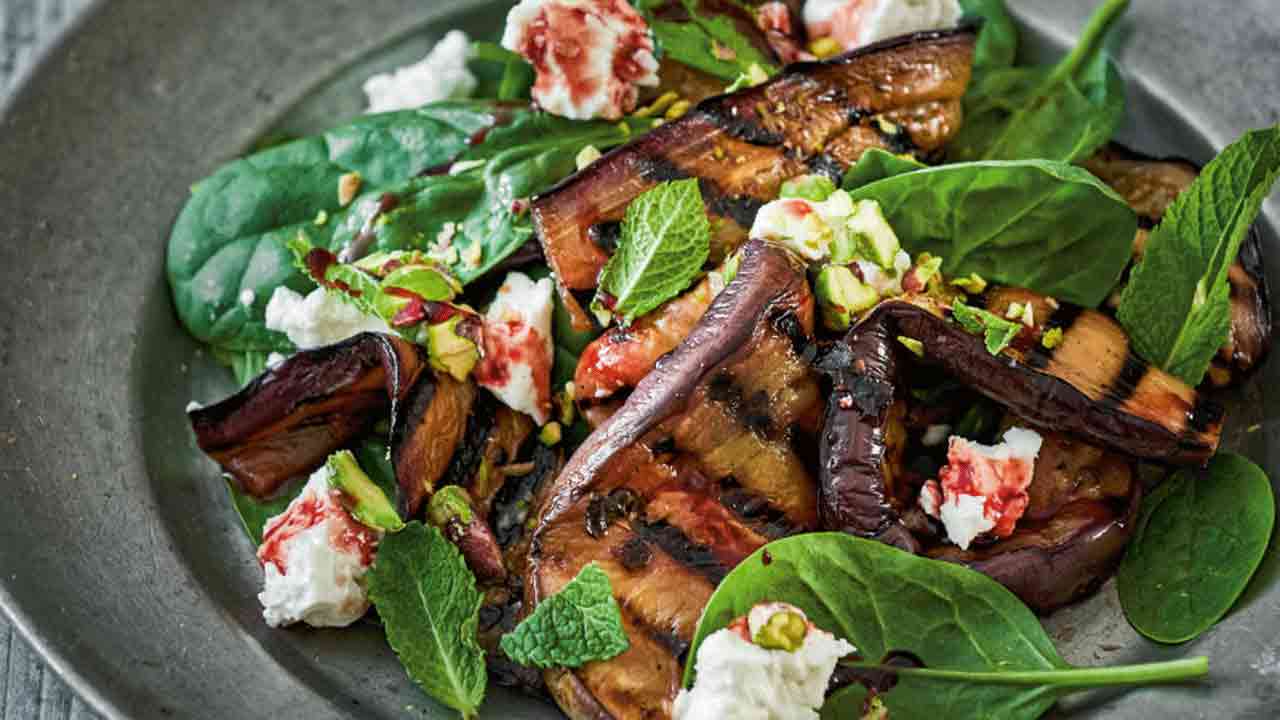 Warm salad of sweet and sour eggplants with cheese and pistachios