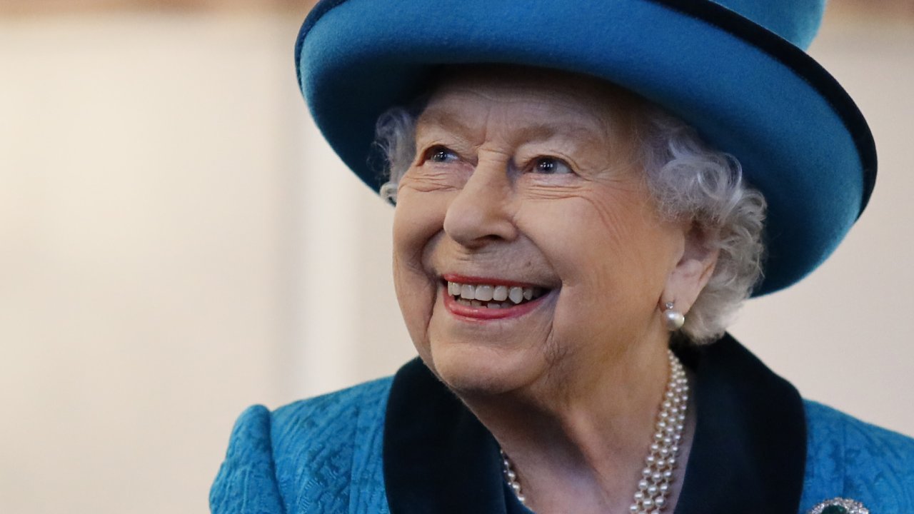 Queen Elizabeth celebrates stamp collector society’s 150th anniversary with a grin