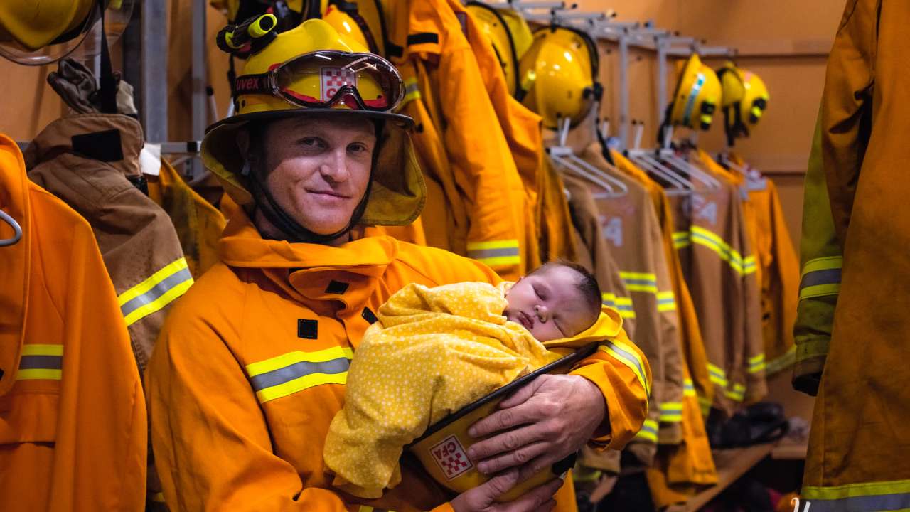 Photo of firefighter and newborn son captures hope amidst bushfire crisis