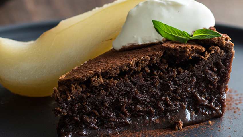 Try this for a sweet delight: Chocolate mousse cake with poached pears and crème fraîche