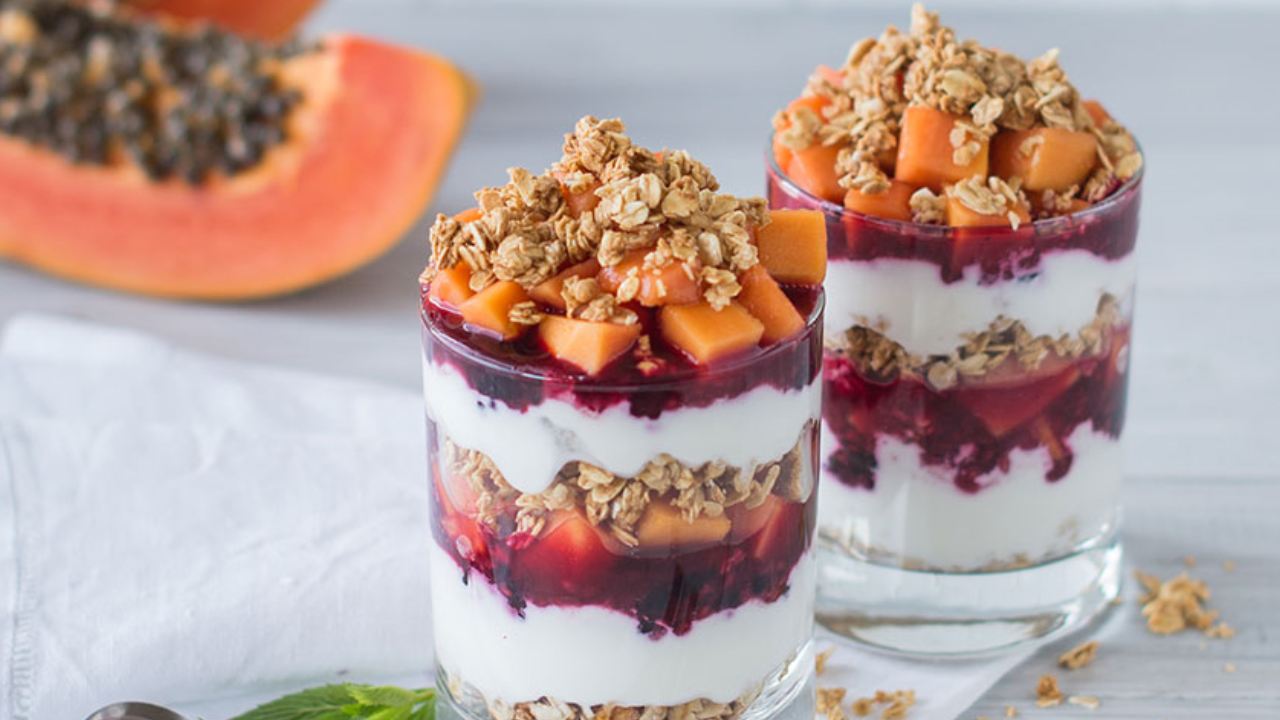 Enjoy sweet red papaya and mixed berry parfaits