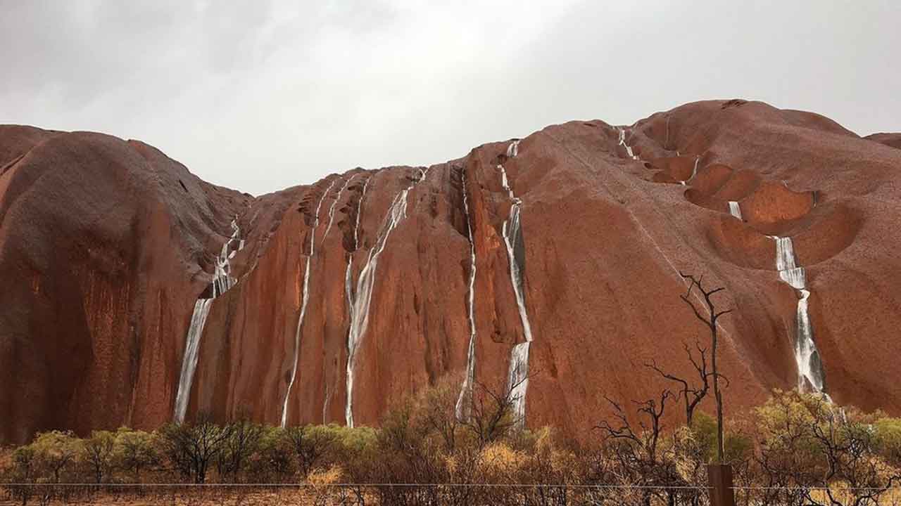 Uluru turns into a waterfall in “rare and magical” sight